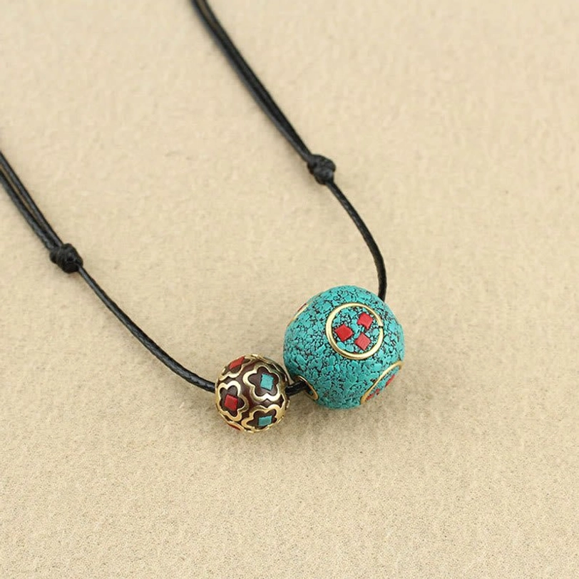 Tibetan turquoise necklace simple display on tabletop showing overall design and adjustable cord construction