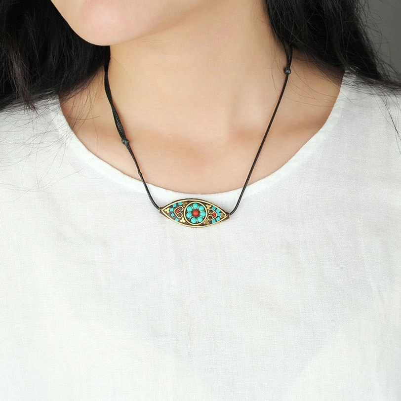 Tibetan turquoise pendant necklace worn at collarbone on model, elegant slim black cord