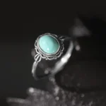 925 sterling silver tibetan protection ring with turquoise stone set in ornate filigree bezel, overhead view