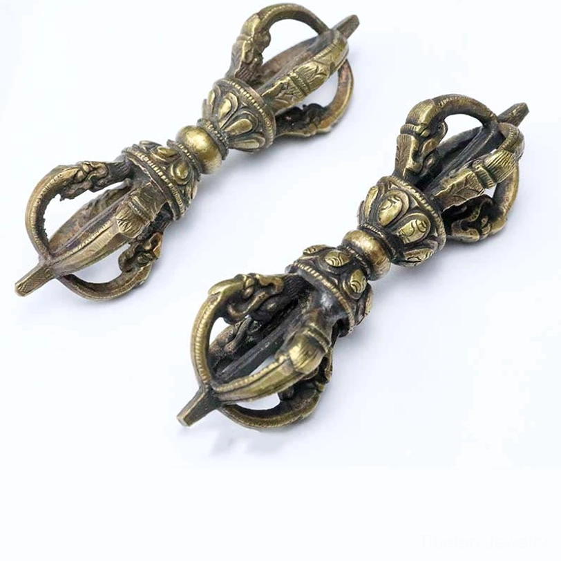 Tibetan Vajra Dorje detail shot emphasizing hand-carved religious symbols and traditional Nepal craftsmanship on bronze ritual object