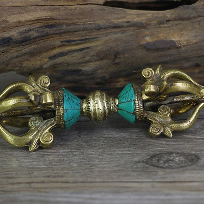 Side view of traditional Tibetan five-prong vajra dorje showing detailed prong structure and turquoise inlay