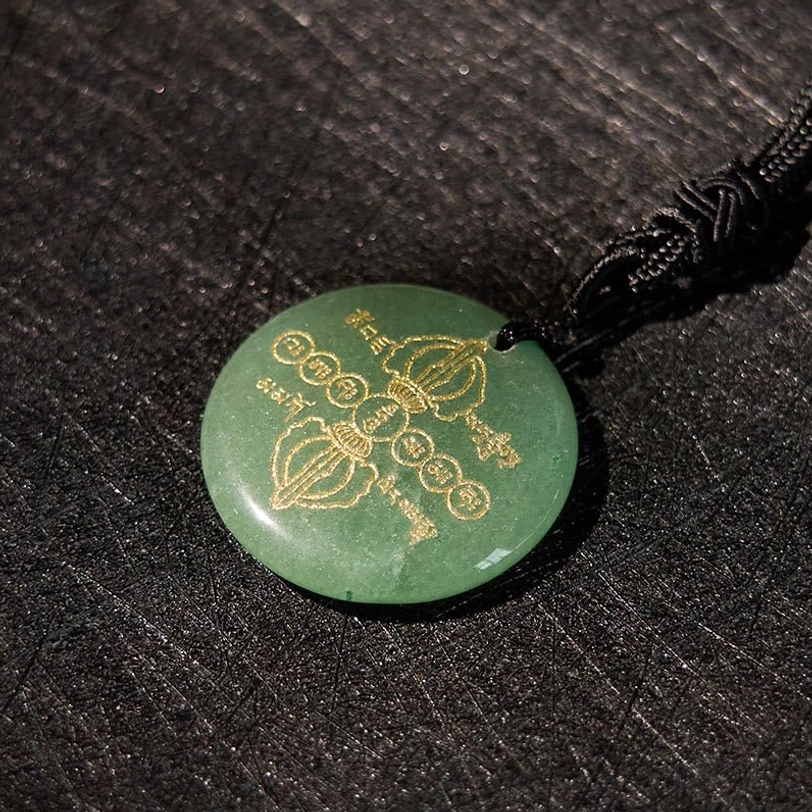 Tibetan Vajra Dorje necklace pendant with gemstone and golden engravings, spiritual Buddhist accessory