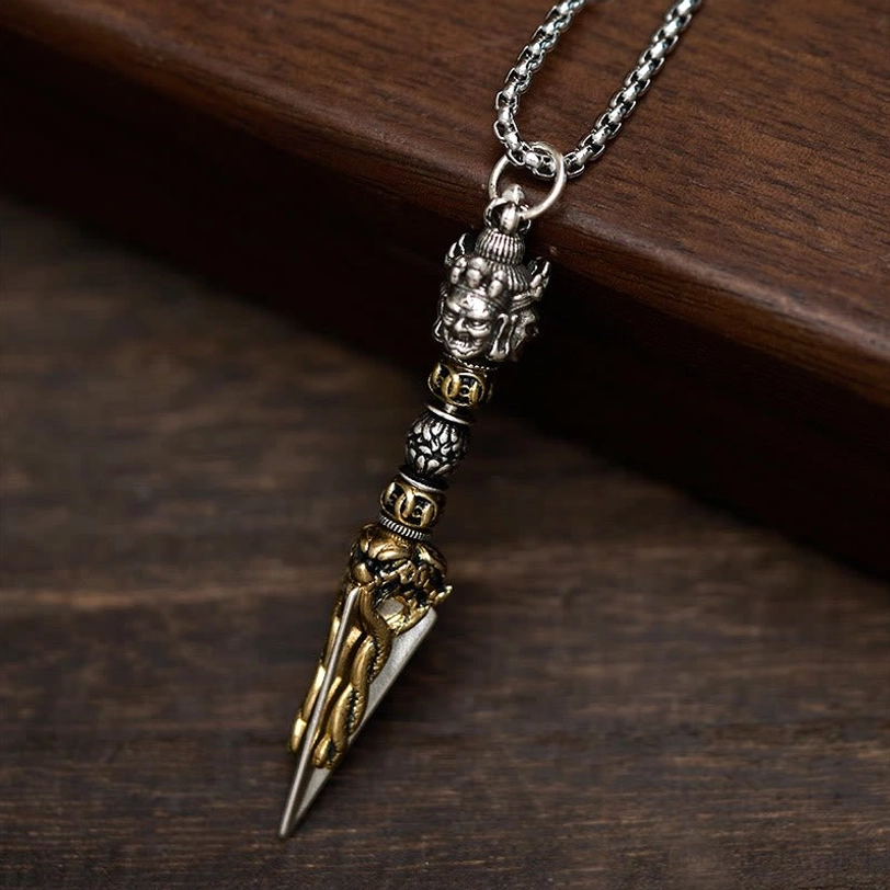 Tibetan Vajra Kila pendant necklace with silver wheat chain front view on wooden tabletop showing full design