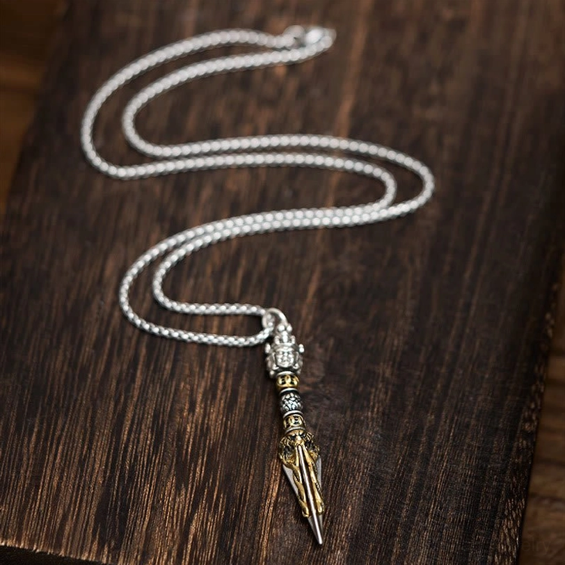 Tibetan Vajra Kila copper pendant necklace flat lay with silver chain on dark wooden table