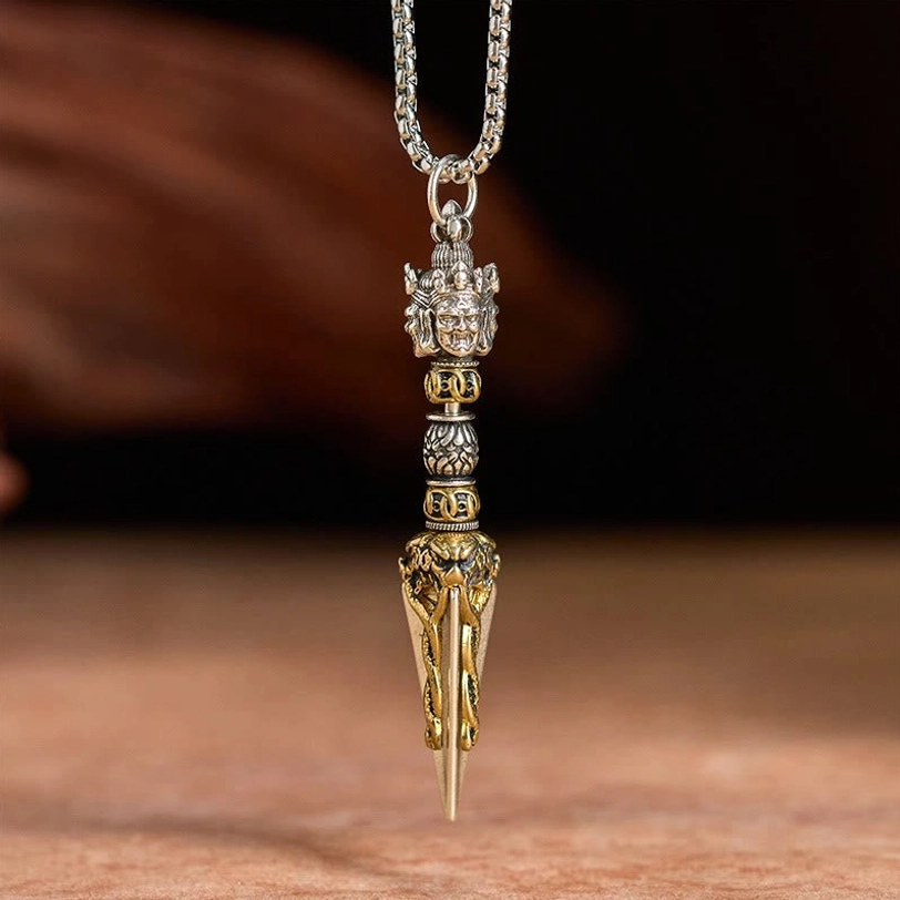 Tibetan Vajra Kila pendant hanging necklace full length view with bicolor finish on warm wooden background