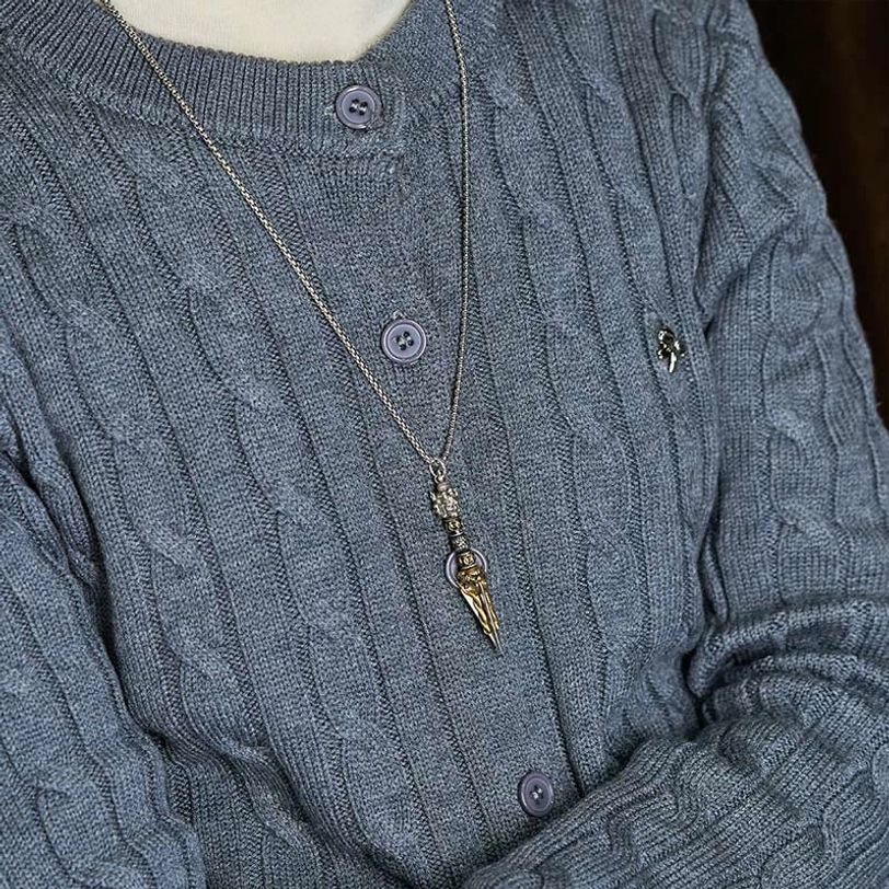 Tibetan Vajra Kila necklace wearing style on gray knitted sweater showing daily spiritual fashion