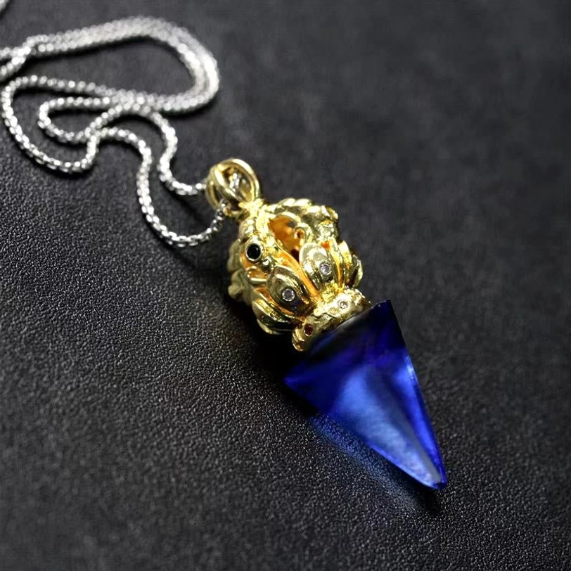 Blue Tibetan pendant necklace with Vajra inspired Liuli crystal drop and ornate gold tone top