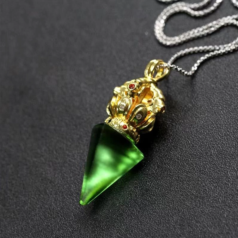 Green Tibetan Vajra Liuli crystal pendant necklace with gold tone cap and red accent