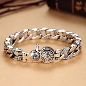 Tibetan Om Mani Padme Hum Double Vajra bracelet in silver copper, front view on wooden surface showing intricate mantra engravings