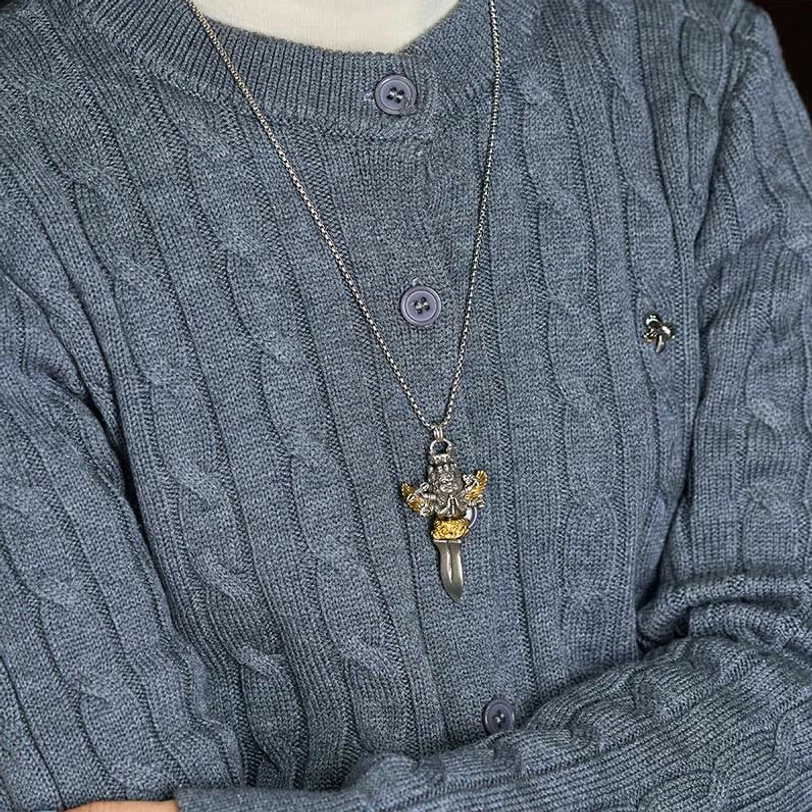 Wearable Tibetan Vajra pendant necklace on model wearing grey knitted sweater, thin silver chain with small daily spiritual jewelry pendant