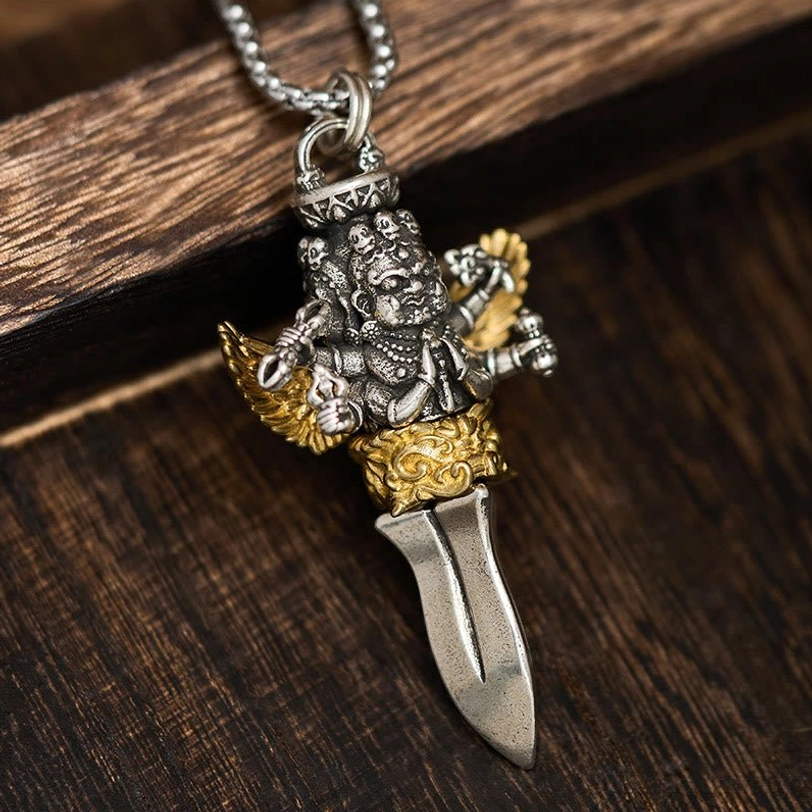 Three Heads Six Arms Tibetan Vajra copper pendant with dual-tone silver and gold finish, top view showcasing intricate deity carving and dagger design