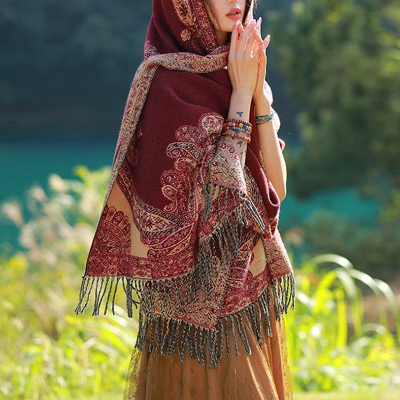 Back view of Tibetan vine leaf shawl with fringe hem worn outdoors by lakeside