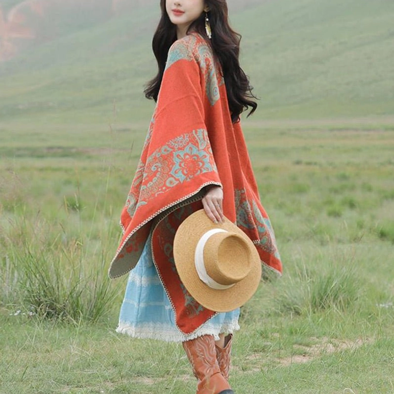 Orange color variant of Tibetan warm wrap poncho shawl vibrant hue on grassland background