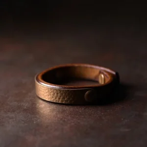 Handcrafted Tibetan copper brass leather wealth bracelet with hammered metal panel and brown leather strap, vintage style side view