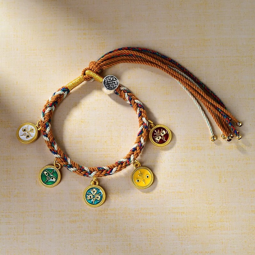 Tibetan multicolored rope wealth bracelet side angle showing detailed enamel metal pendants and adjustable drawstring tassels