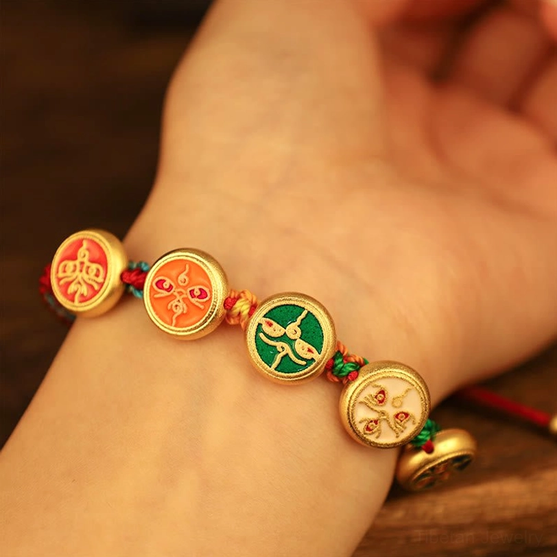 Tibetan five gods of wealth bracelet worn on human wrist showing complete charm sequence and braided rope strap comfort fit