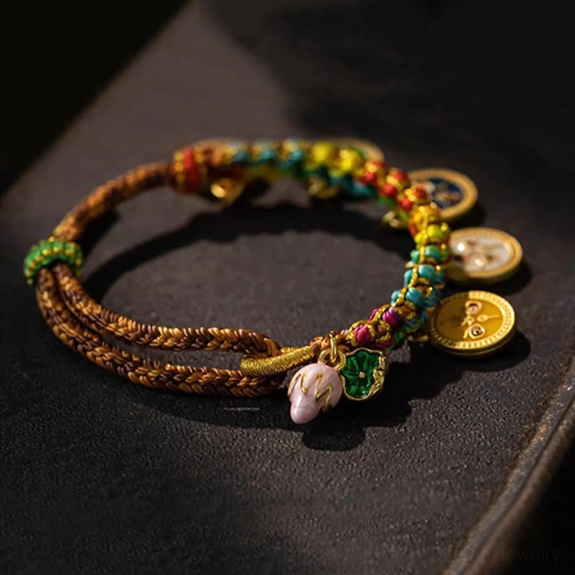 Close-up detail of five gods of wealth fortune bracelet showing braided rope sections and hanging round enamel pendants