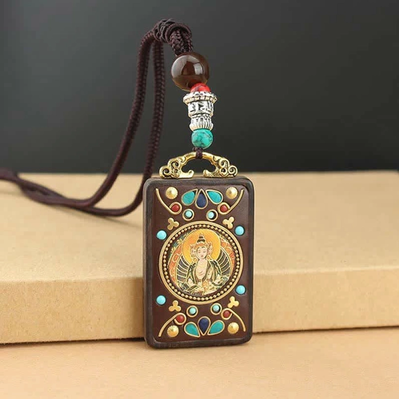 Tibetan wealth deity thangka pendant necklace showing traditional hand-painted sacred artwork on natural wood
