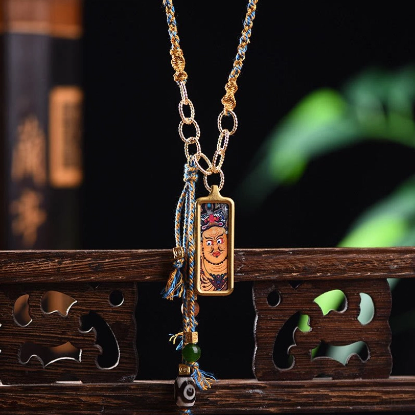 Five Gods of Wealth Tibetan thangka titanium steel necklace pendant with gold frame on wooden backdrop