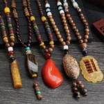 Collection of handmade Tibetan wenge wood bodhi seed necklaces with mixed agate and resin pendants in various styles