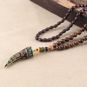 Tibetan horn pendant necklace side angle view showcasing wenge wood beads, vintage metal pendant with enamel inlays, and colorful spacer beads