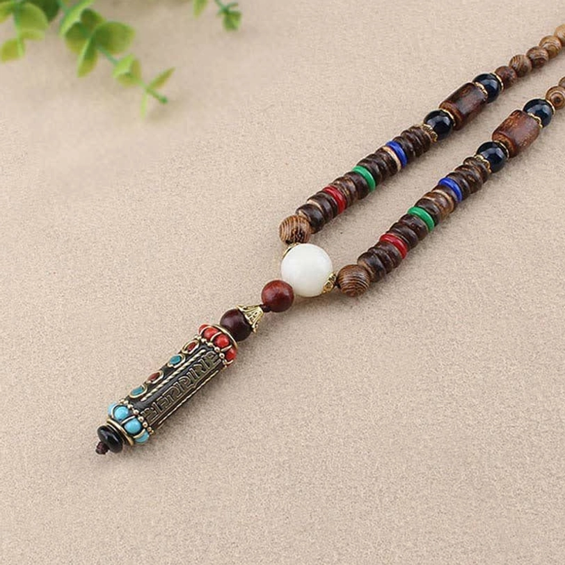 Tibetan wooden bead necklace with colorful ring spacers and enamel mantra pendant