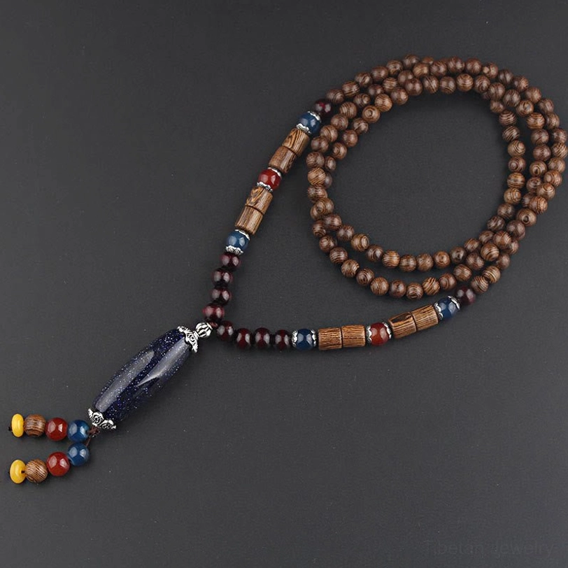 Wenge wood and turquoise thousand-eyed bodhi seed necklace flat lay with ethnic spiritual design