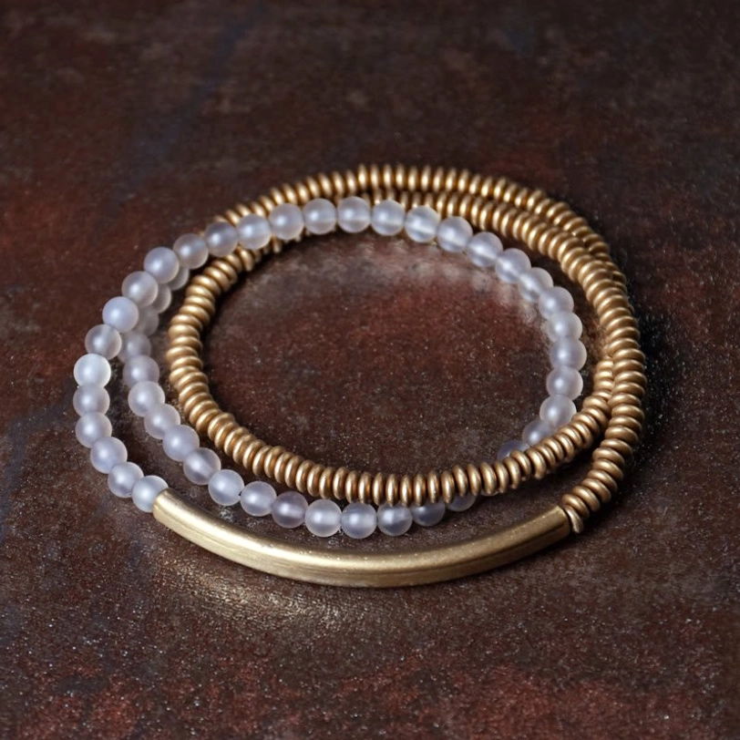 White agate Tibetan triple wrap bracelet highlighting milky stone beads and warm brass accents close-up