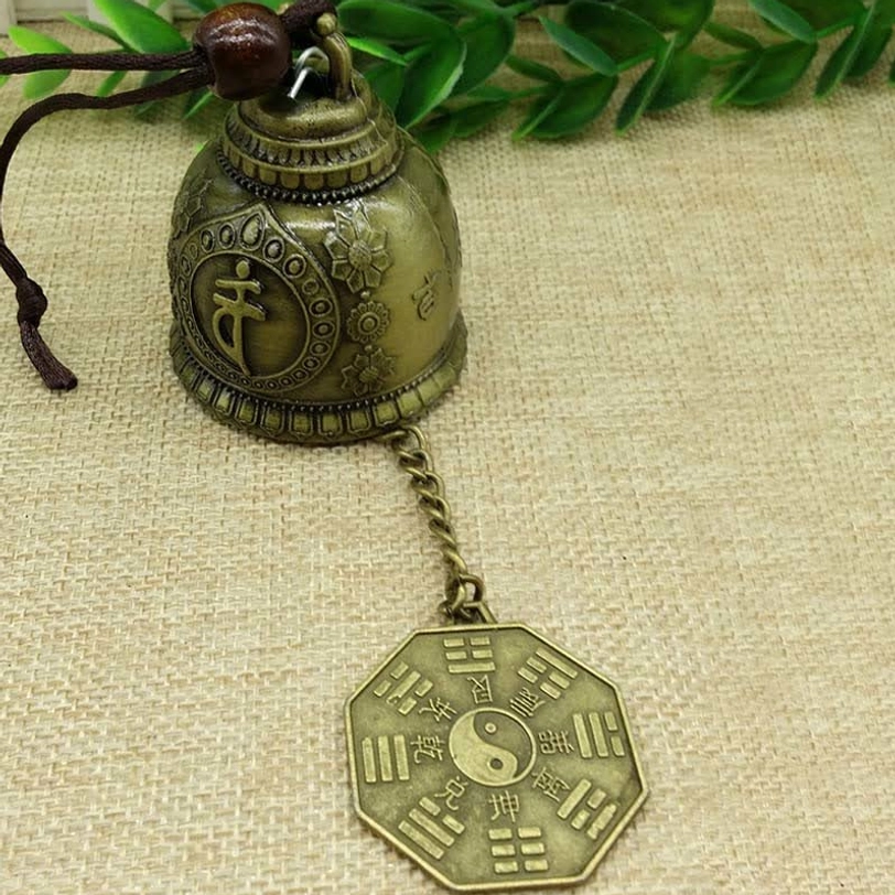 Tibetan feng shui wind chime bell with hemp rope hanger and fish charm suspended for meditation space