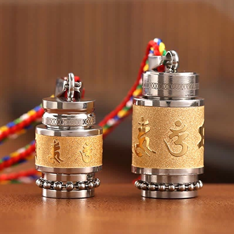 Pair of Tibetan prayer wheel amulets with different engraved Sanskrit mantras and colorful hanging rope