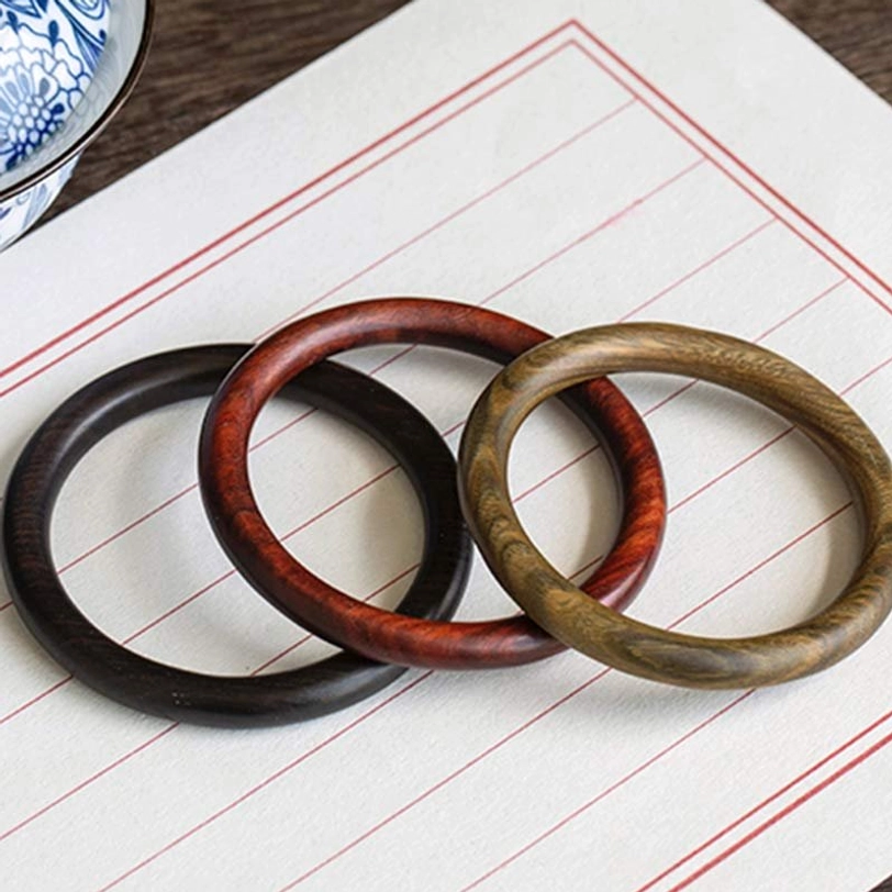 Tibetan triple wood protection bracelet worn on wrist - lifestyle image showing natural beauty of handcrafted bangle
