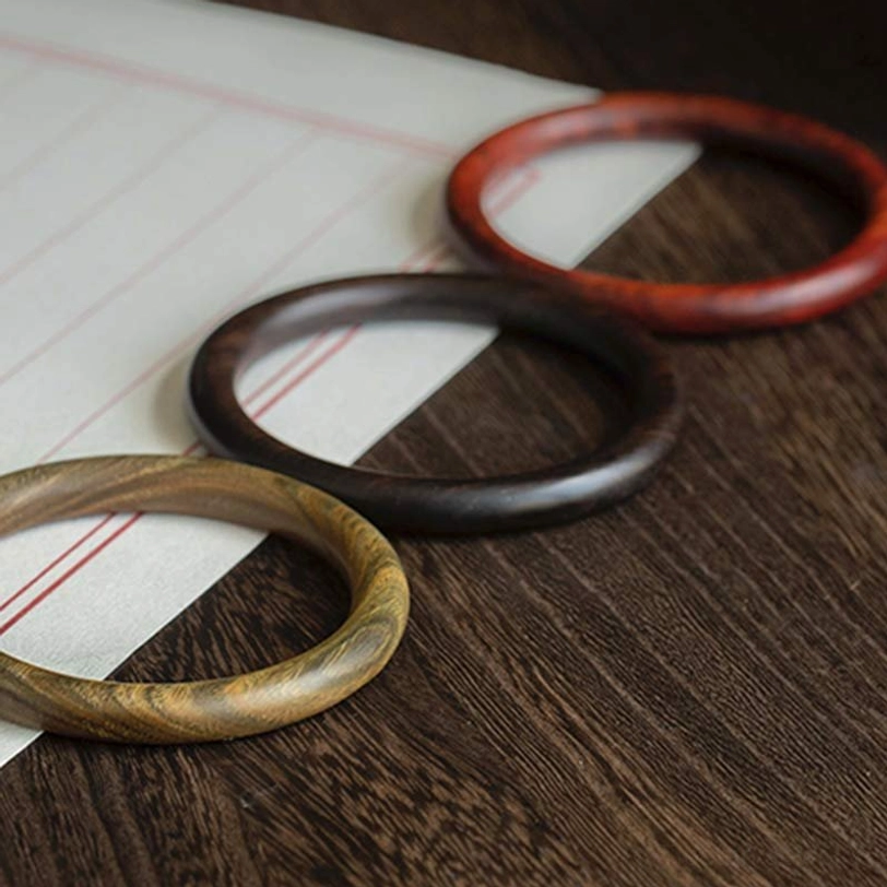 Tibetan wood protection bracelet displaying natural color variations - authentic handmade bangle with unique characteristics