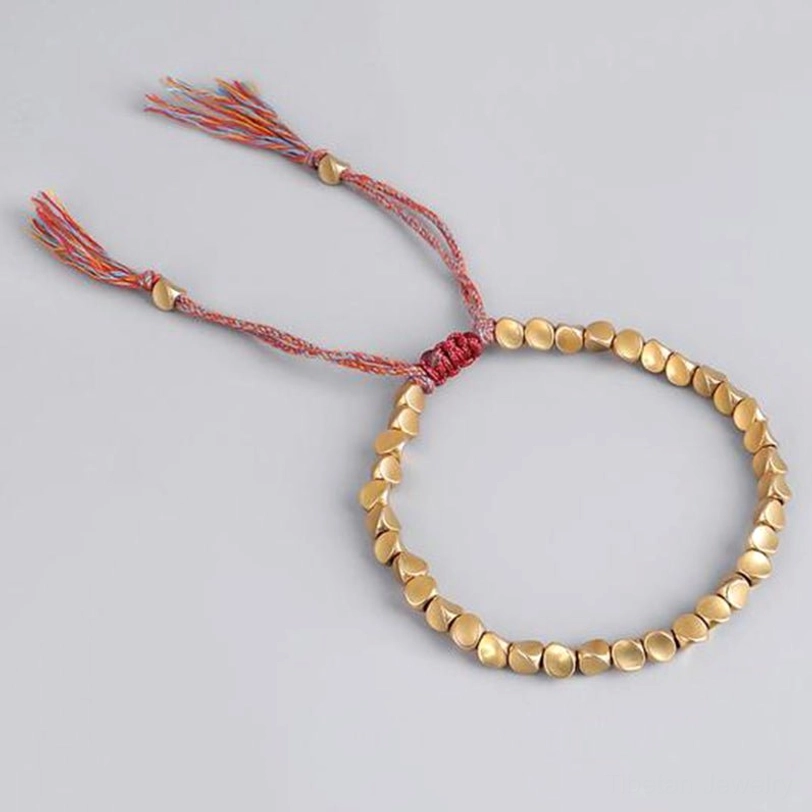 Handmade Tibetan woven bracelet with matte gold round copper beads and pure red woven strap