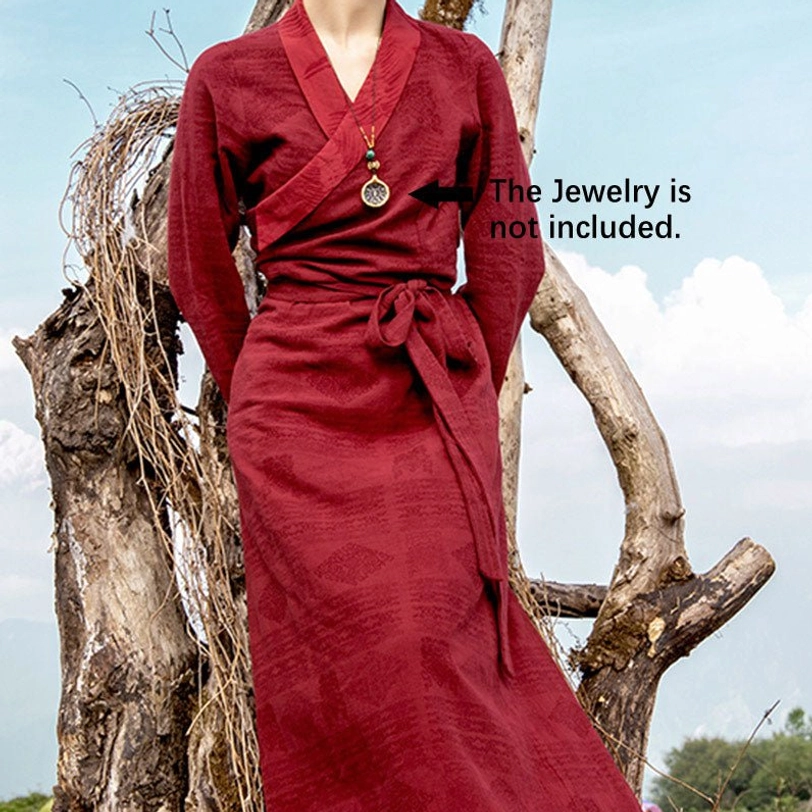 Side-front full-length view of Tibetan wrap maxi dress with cross V-neck, self-tie waist belt, and flowing fabric silhouette