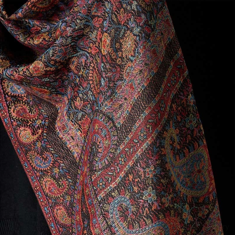 Intricate jacquard weave detail of Tibetan shawl, showing fine craftsmanship and three-dimensional pattern texture