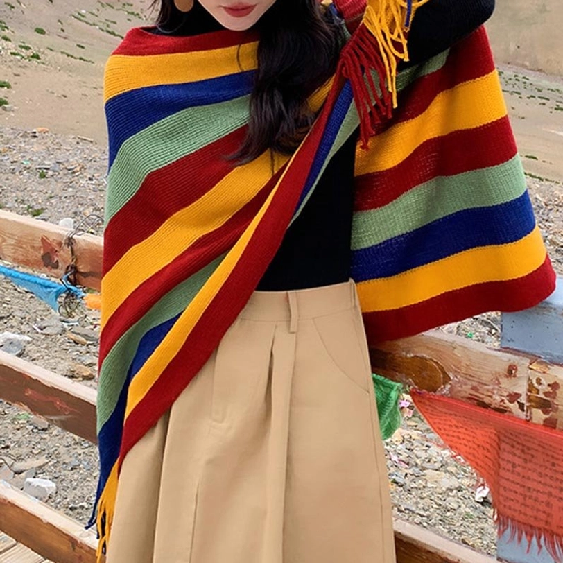 Tibetan striped wrap shawl worn at left side showing shoulder tassel fringe on mountain plateau