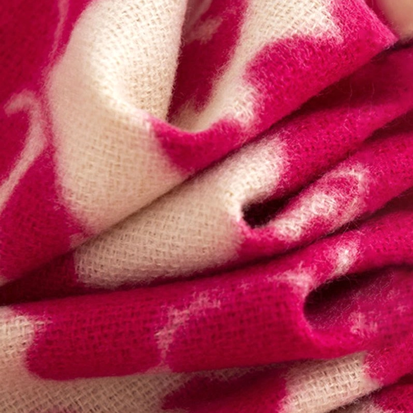 Side close-up view of crumpled tibetan shawl fabric showing soft wool-like texture and two-tone floral print