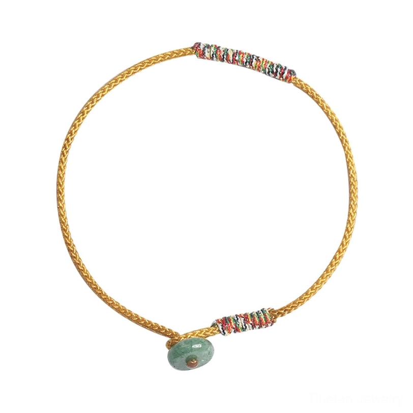 Yellow Tibetan braided luck bracelet with dual colorful woven wraps and green aventurine donut pendant