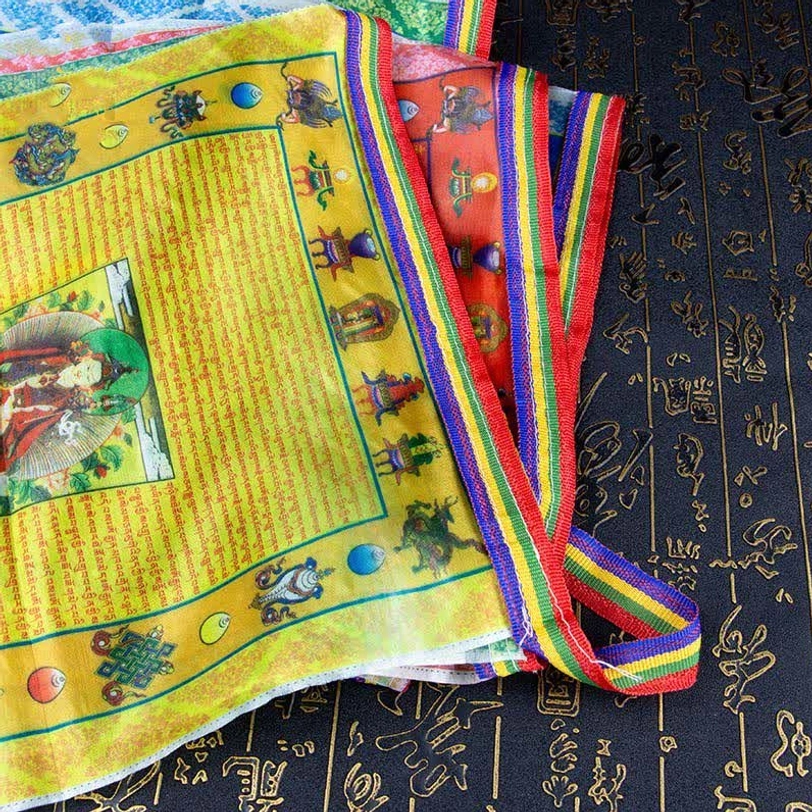 Stacked yellow Tibetan windhorse prayer flags with woven rainbow border and Buddhist sutras on calligraphy fabric