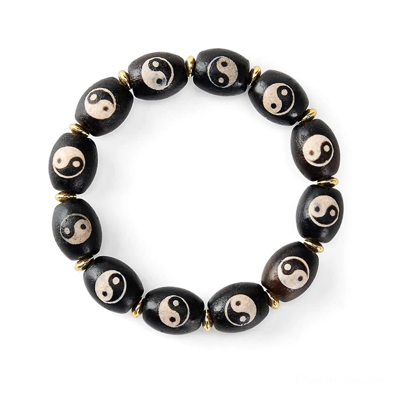 Tibetan Dzi Bead protection bracelet on white background showing sharp detail of black agate beads with pristine white Yin Yang symbols and gold separators