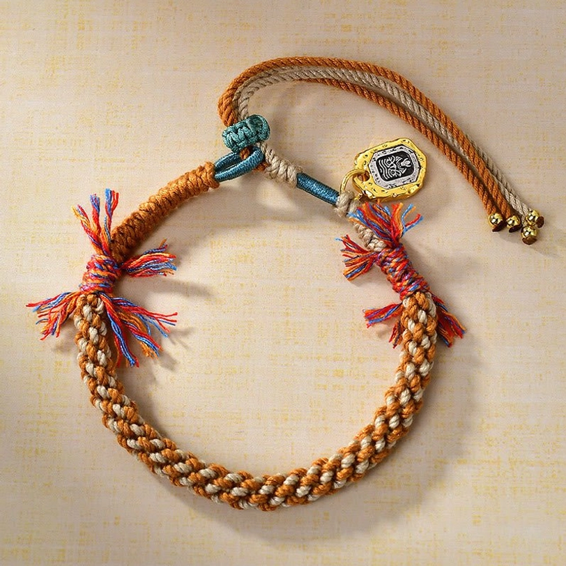 Tibetan engraved Zakiram charm bracelet with copper pendant, colorful rope weaving, and protective symbolism - side view