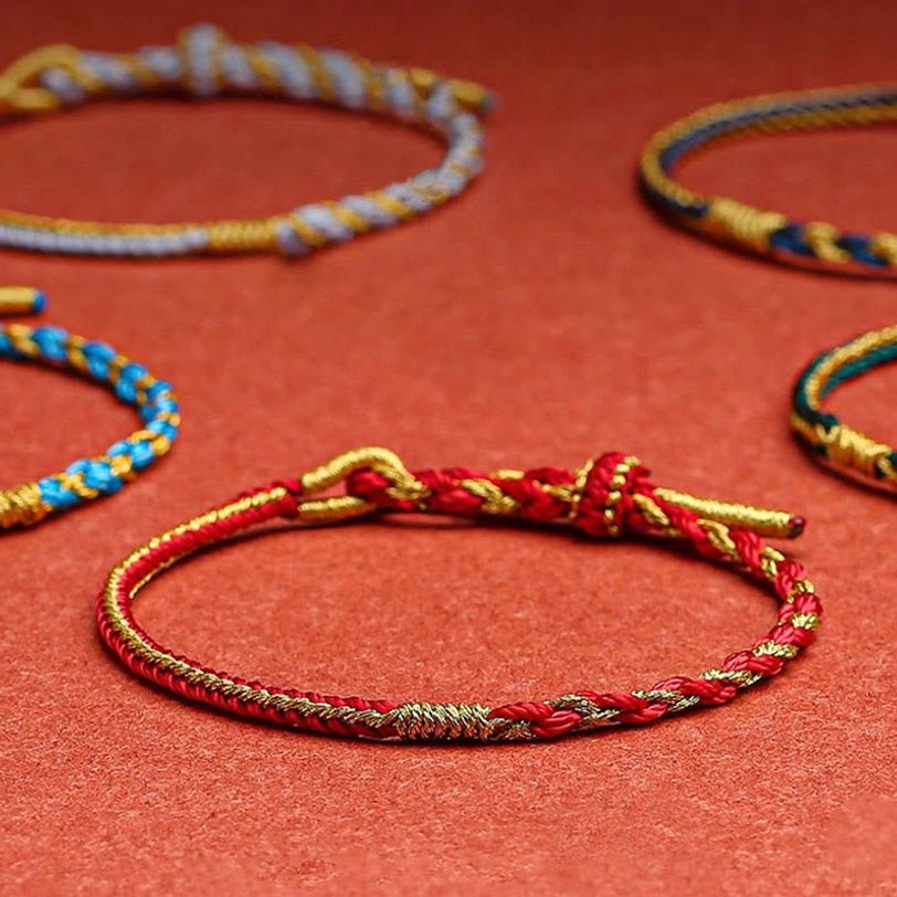 Multiple color variants of handmade Tibetan zodiac protection bracelets in flat lay arrangement