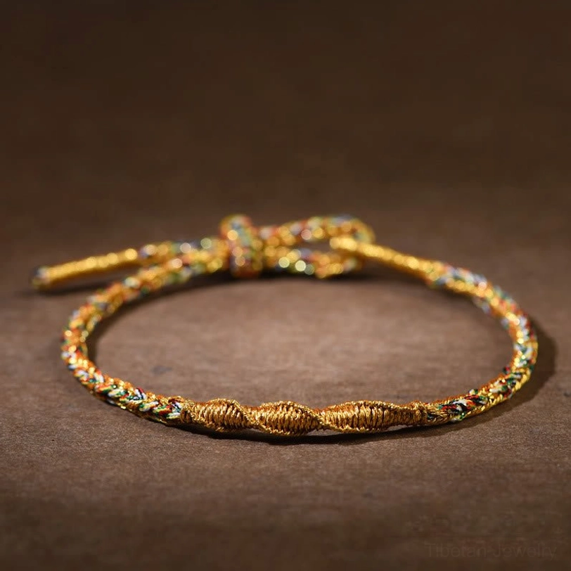 Yellow Tibetan zodiac natal buddha braided bracelet with adjustable knot and gold twisted weave detail