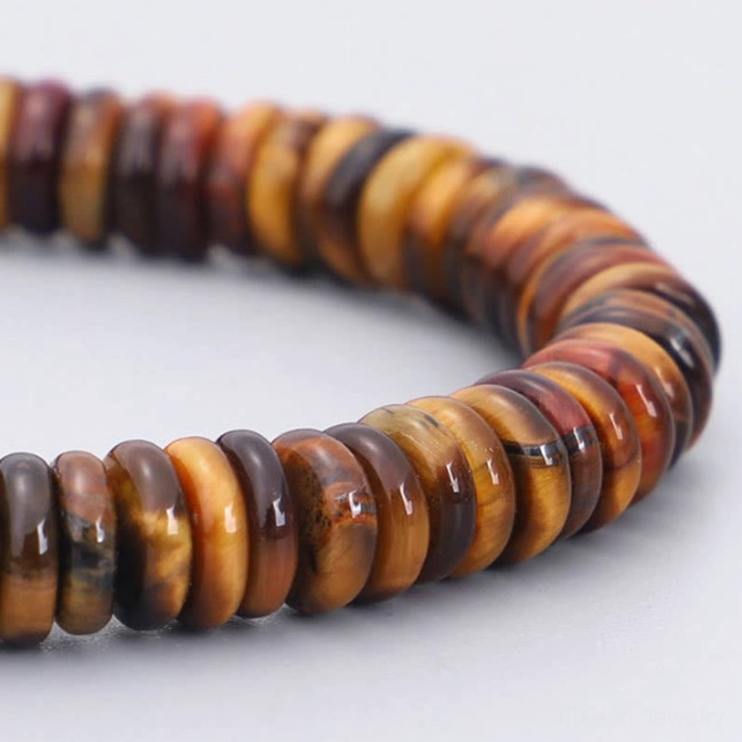 Tiger eye natural stone beads close up showing golden brown striations and polished disc bead texture