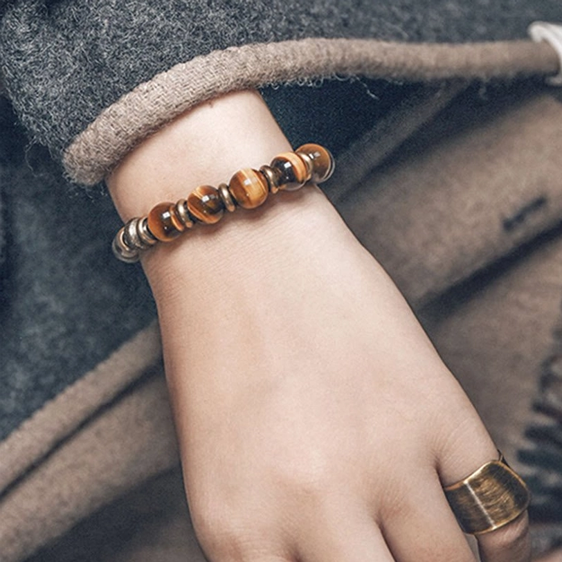 Smooth barrel-cut tiger eye stone beads on premium elastic cord, understated spiritual bracelet design
