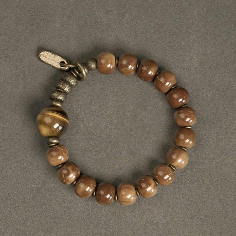 Gradient brown tiger eye beads with brass metal parts and branded tag, product flat view