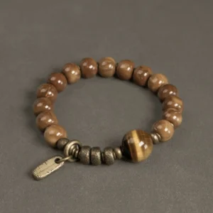Tiger eye and kuka seed beaded bracelet with brass accents, top-down flat lay view