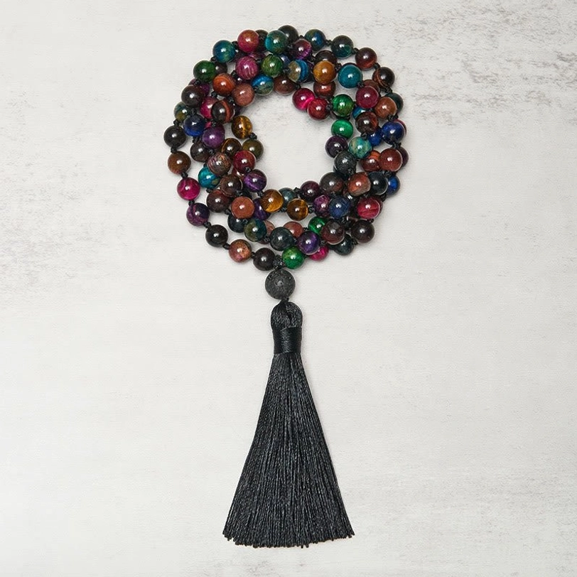 Multicolor tiger eye 108 bead mala necklace flat lay showing yellow green blue red stones mixed together with black tassel pendant