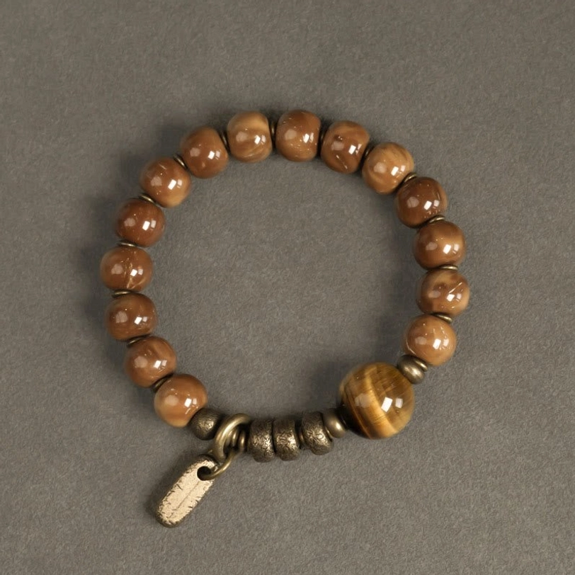 Mixed warm brown tiger eye stone beads with central cat-eye focal bead and brass hardware