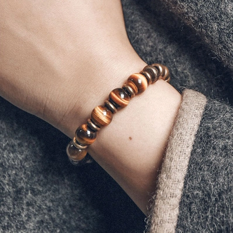 Handcrafted tiger eye stone beaded bracelet on gray fabric, simple elastic string design